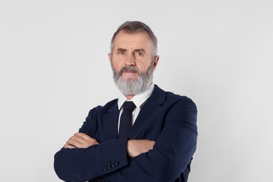 Photo of Portrait of senior man in suit on white background