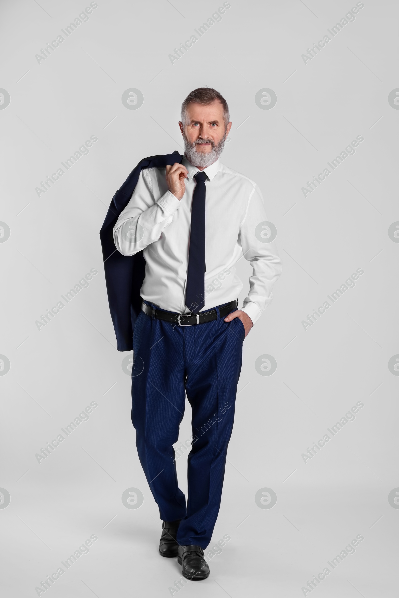 Photo of Portrait of senior man in suit on white background