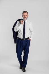 Photo of Portrait of senior man in suit on white background