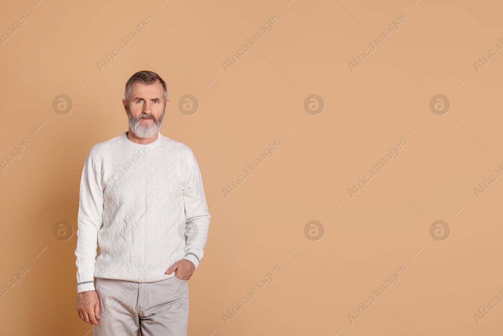 Photo of Portrait of senior man on beige background, space for text