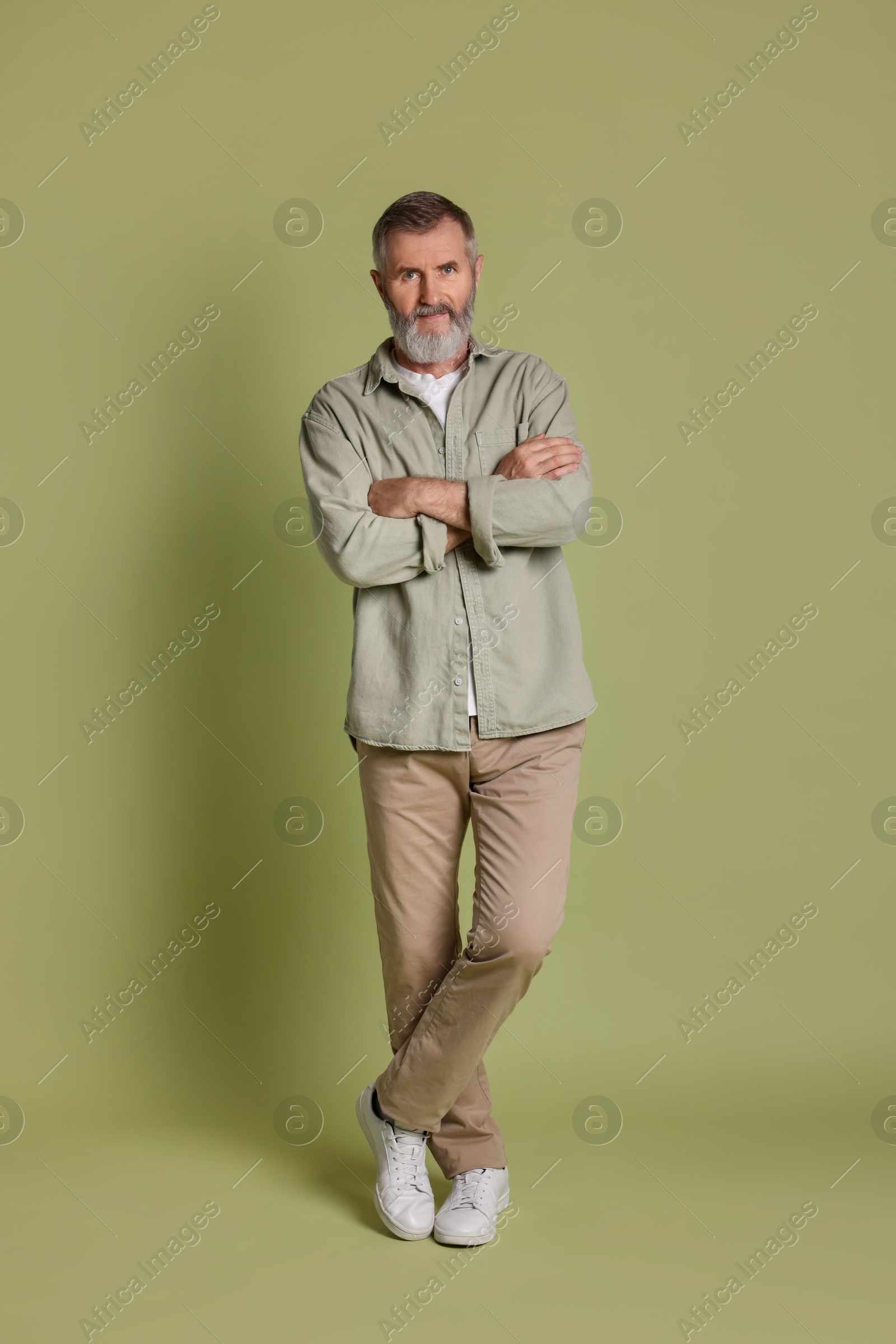 Photo of Portrait of senior man on green background