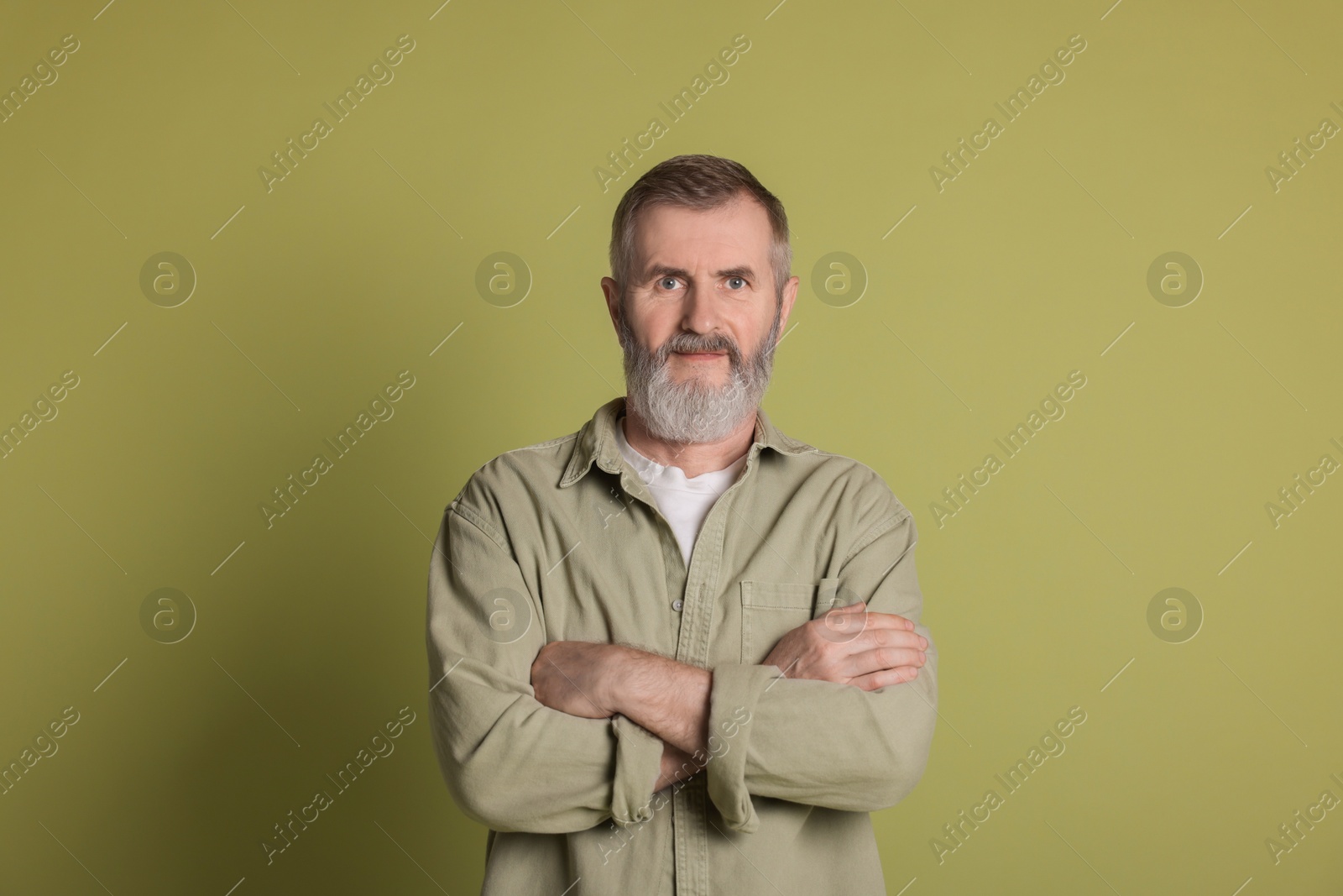 Photo of Portrait of senior man on green background