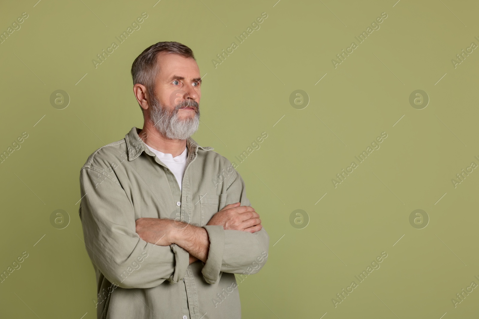 Photo of Portrait of senior man on green background, space for text