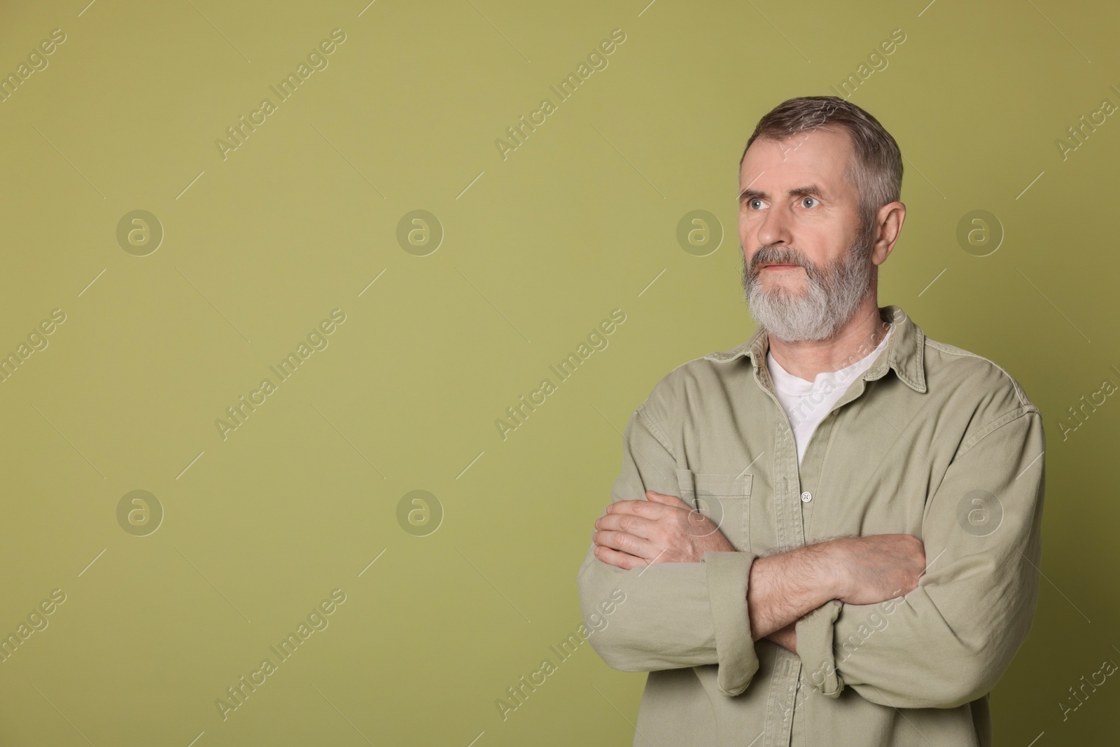 Photo of Portrait of senior man on green background, space for text