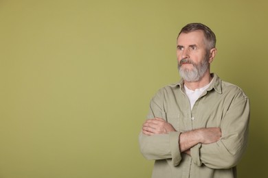 Photo of Portrait of senior man on green background, space for text