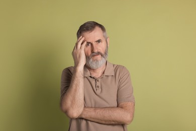 Photo of Portrait of senior man on green background