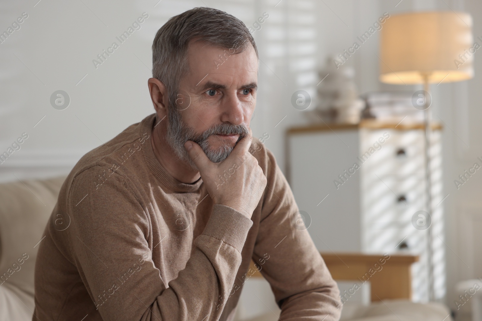 Photo of Portrait of handsome senior man at home, space for text