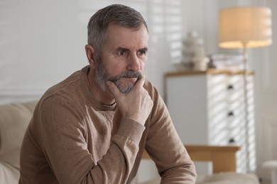 Photo of Portrait of handsome senior man at home, space for text