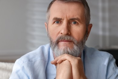 Photo of Portrait of handsome senior man at home