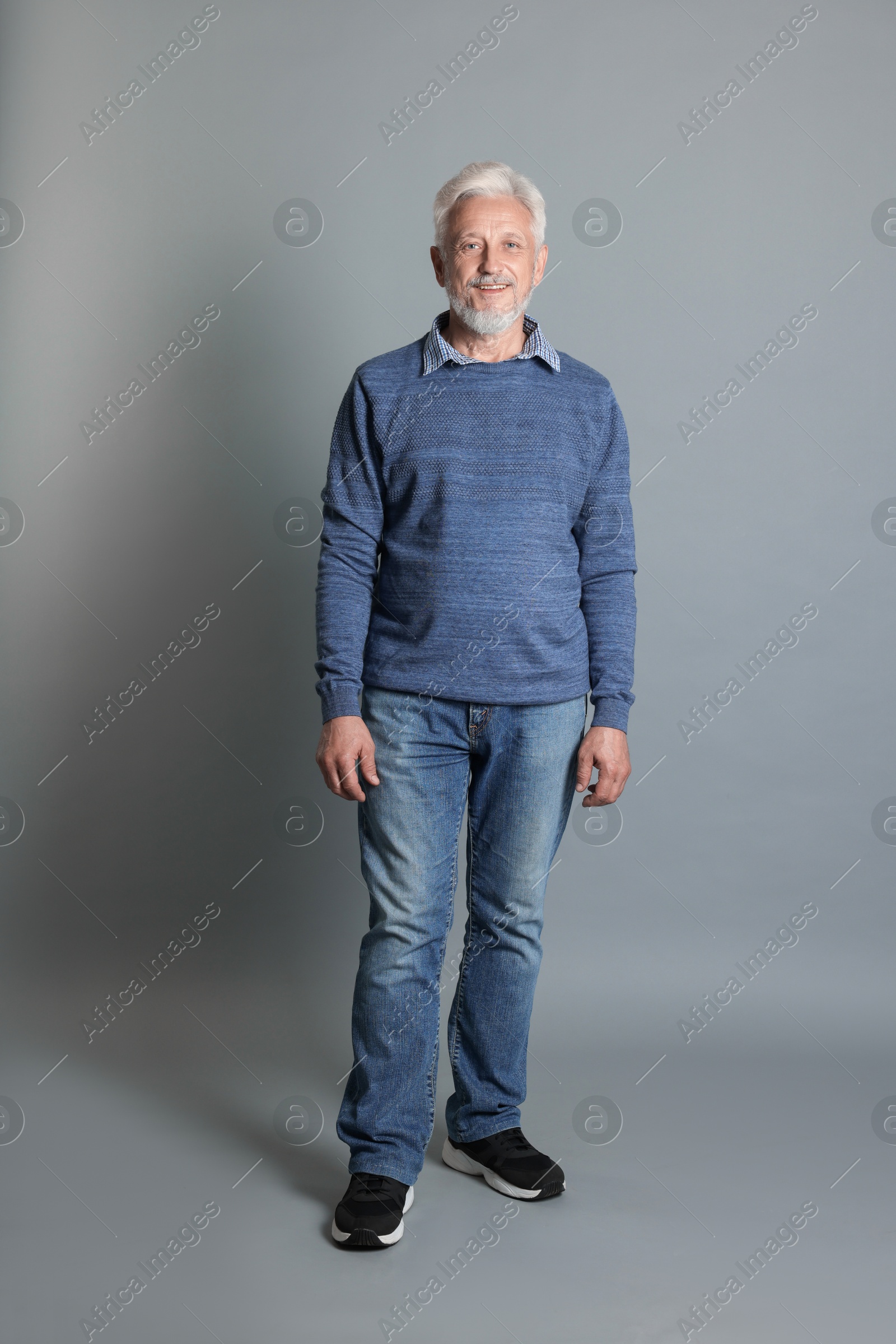 Photo of Full length portrait of senior man on grey background