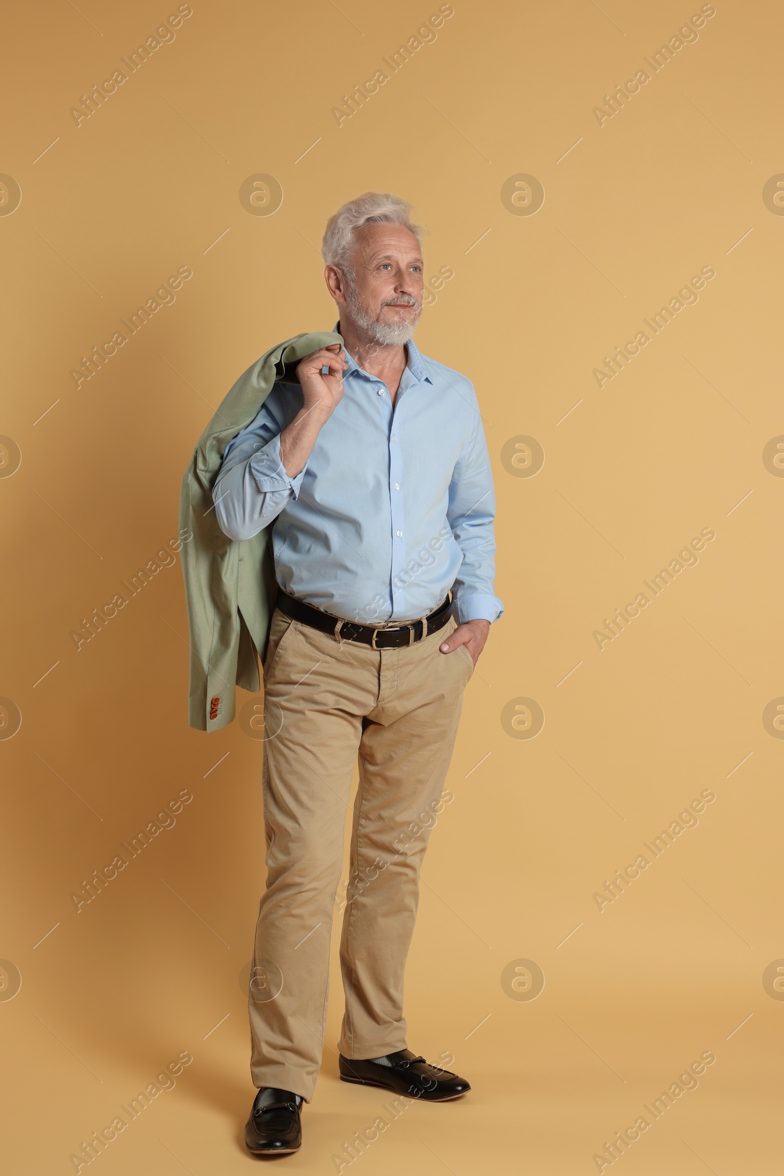 Photo of Full length portrait of senior man on beige background