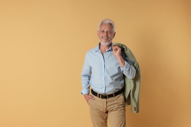 Photo of Portrait of senior man on beige background, space for text