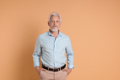 Photo of Portrait of senior man on beige background