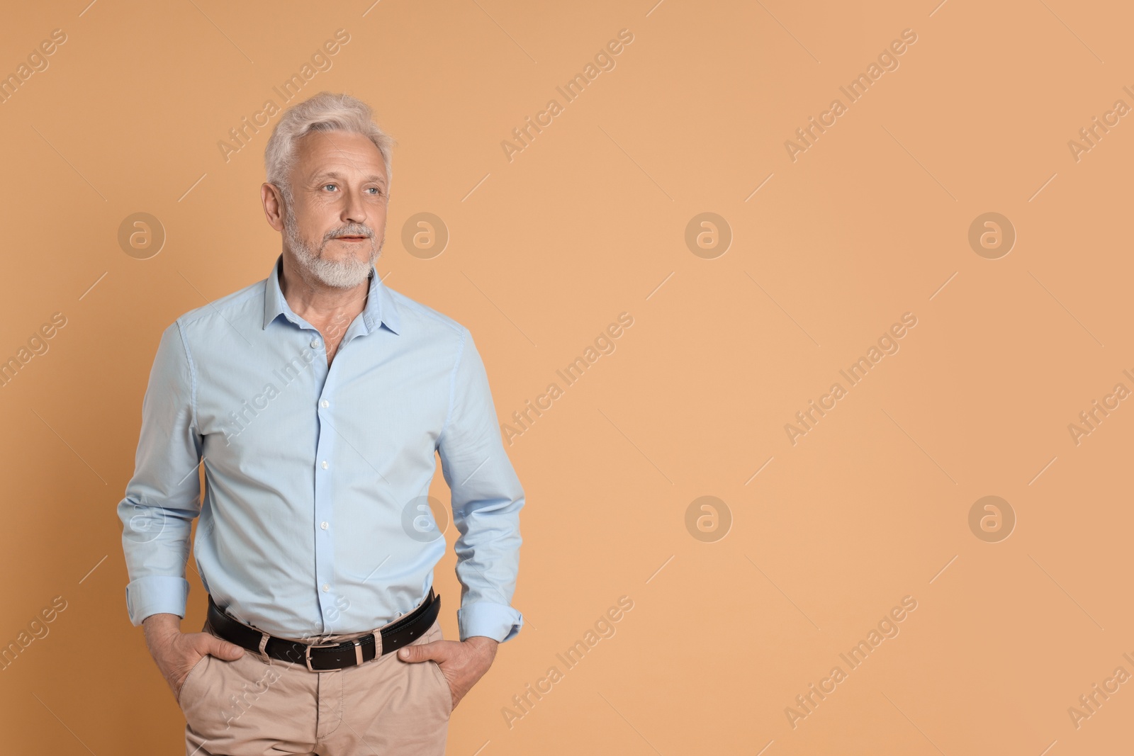 Photo of Portrait of senior man on beige background, space for text