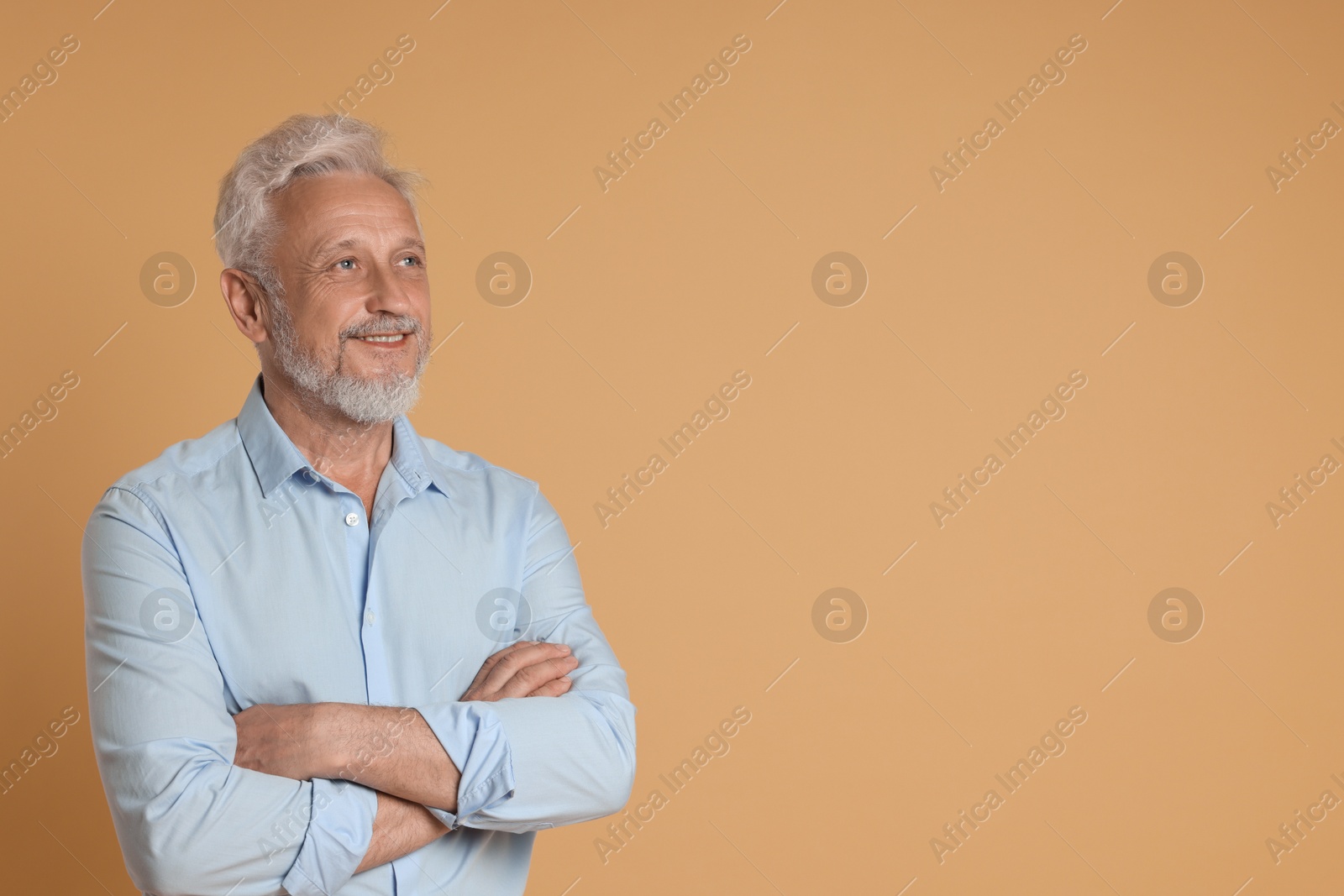 Photo of Portrait of senior man on beige background, space for text