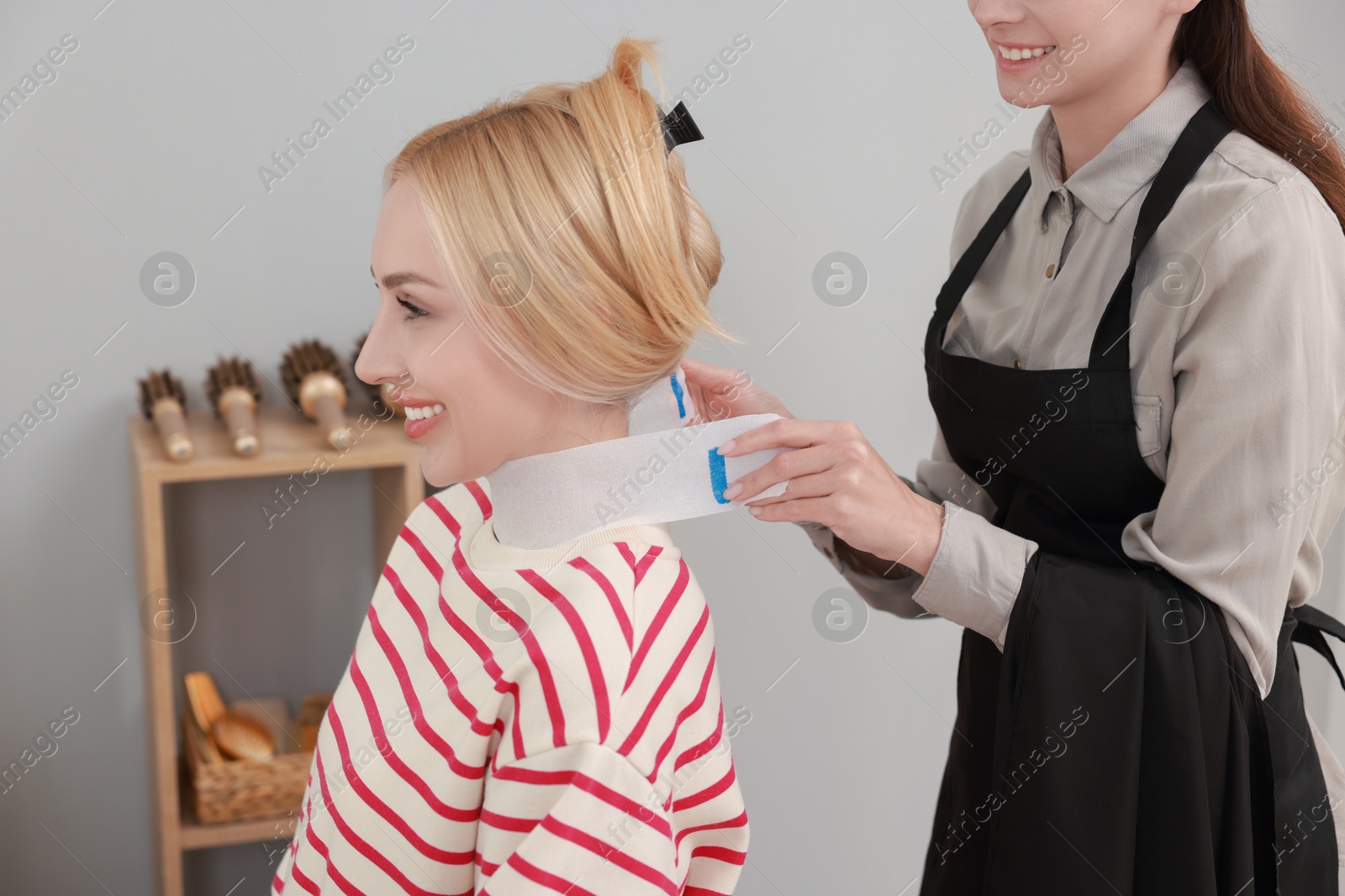 Photo of Hair cutting. Professional hairdresser working with client in salon, closeup