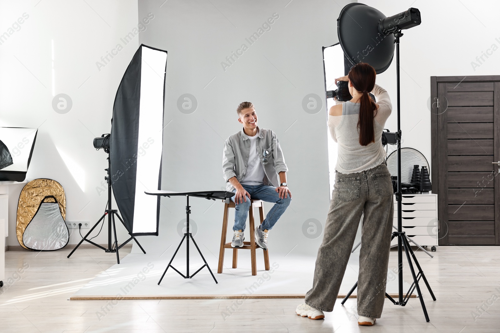 Photo of Photographer working with model in professional photo studio