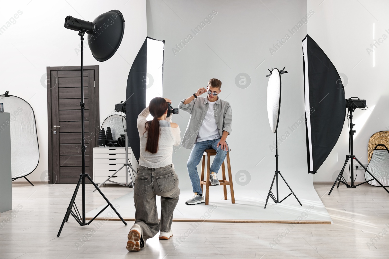 Photo of Photographer working with model in professional photo studio