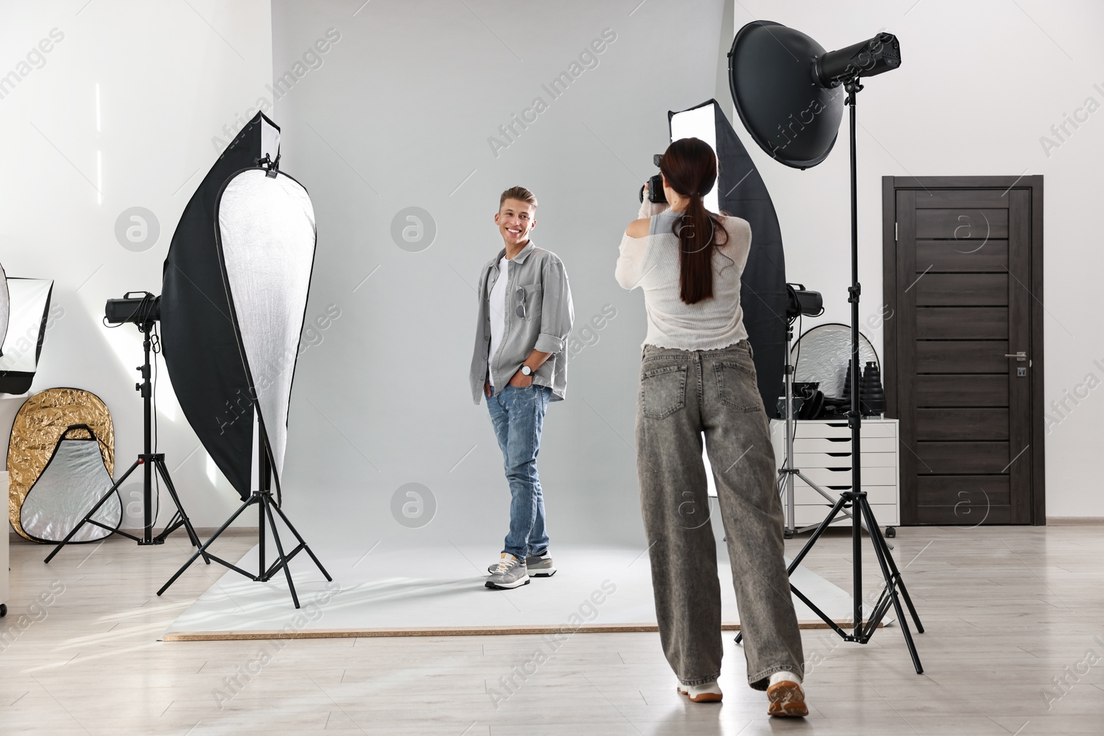 Photo of Photographer working with model in professional photo studio