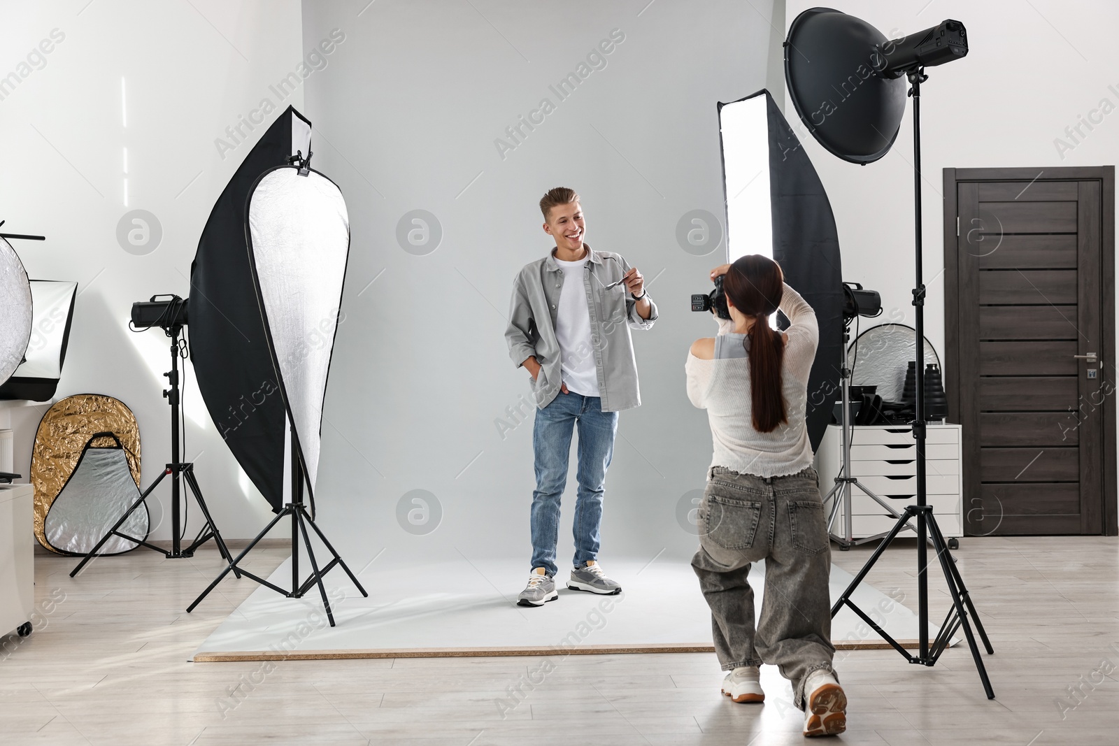 Photo of Photographer working with model in professional photo studio