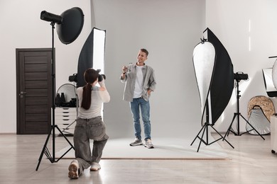 Photo of Photographer working with model in professional photo studio