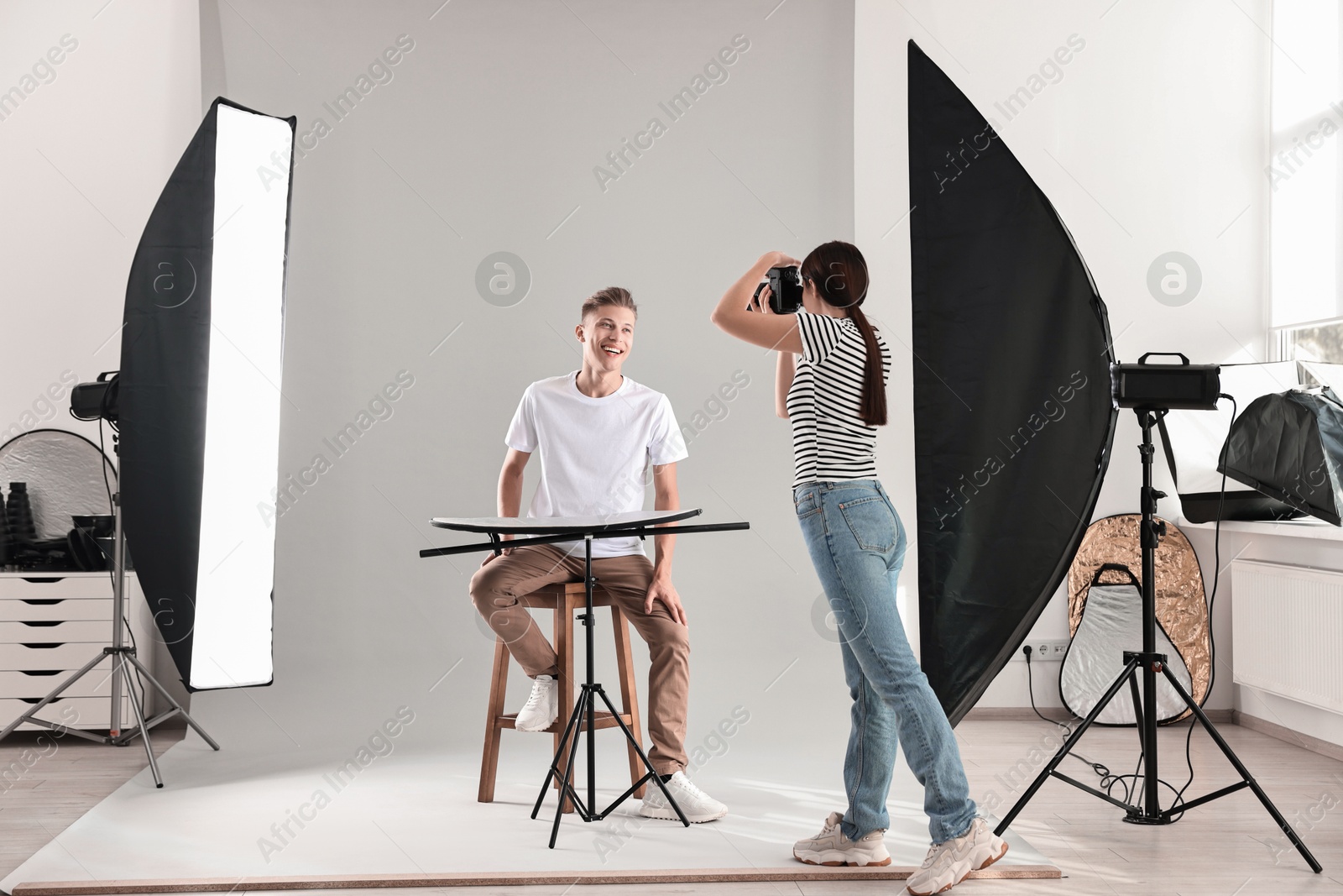 Photo of Photographer working with model in professional photo studio