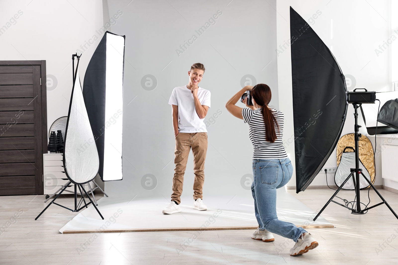 Photo of Photographer working with model in professional photo studio