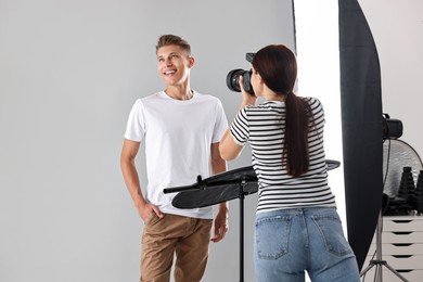 Photo of Photographer working with model in professional photo studio