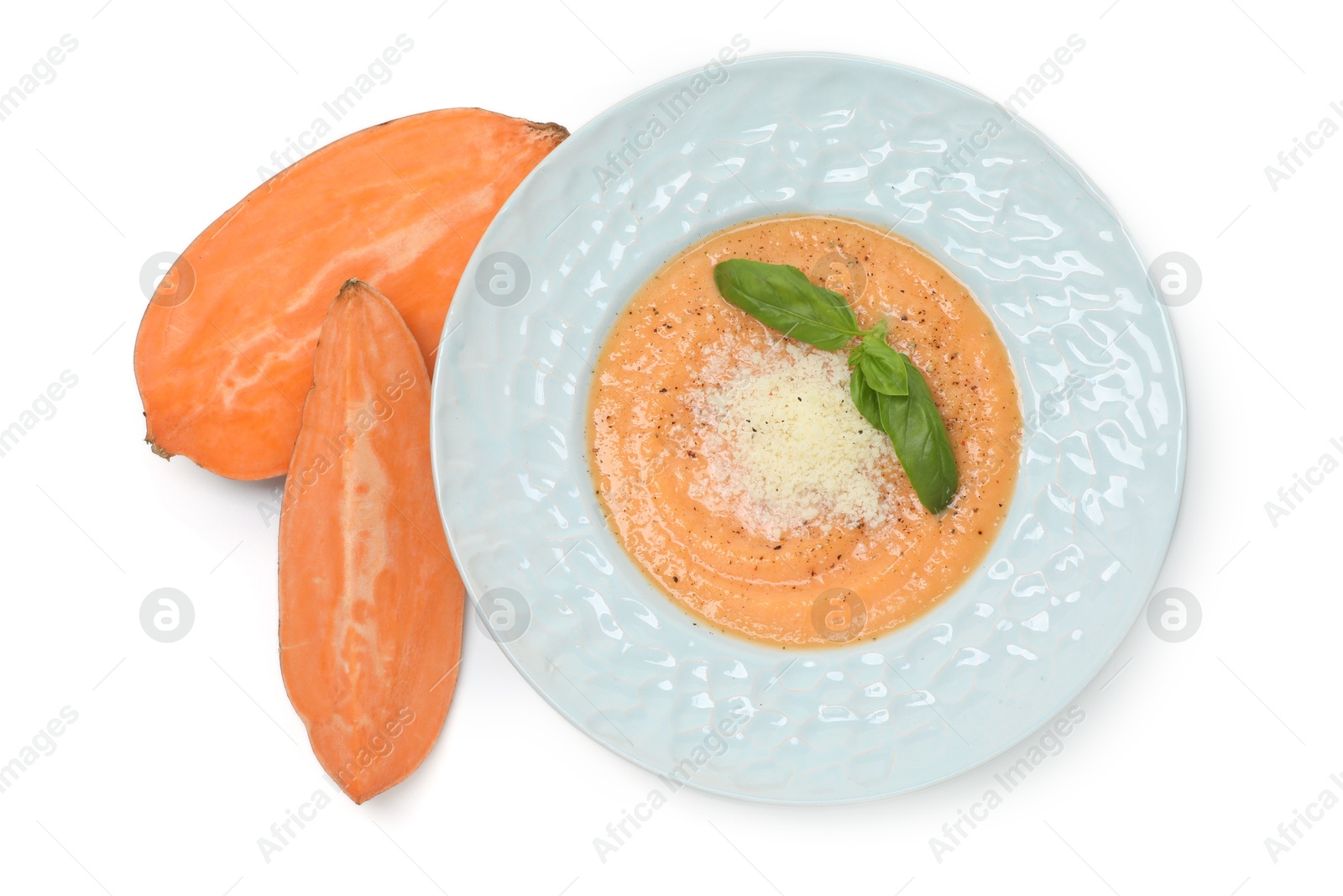 Photo of Delicious sweet potato soup with parmesan cheese and fresh vegetable isolated on white, top view