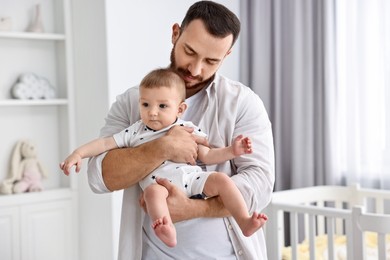 Photo of Dad with his cute little baby at home