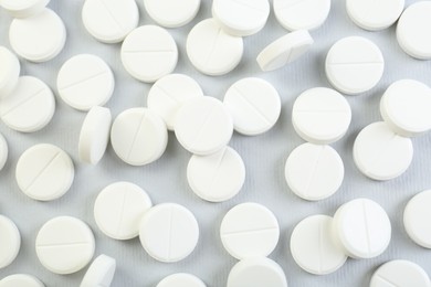 Photo of Many antibiotic pills on grey background, closeup