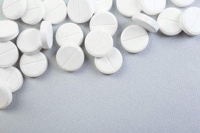 Photo of Many antibiotic pills on grey background, above view. Space for text