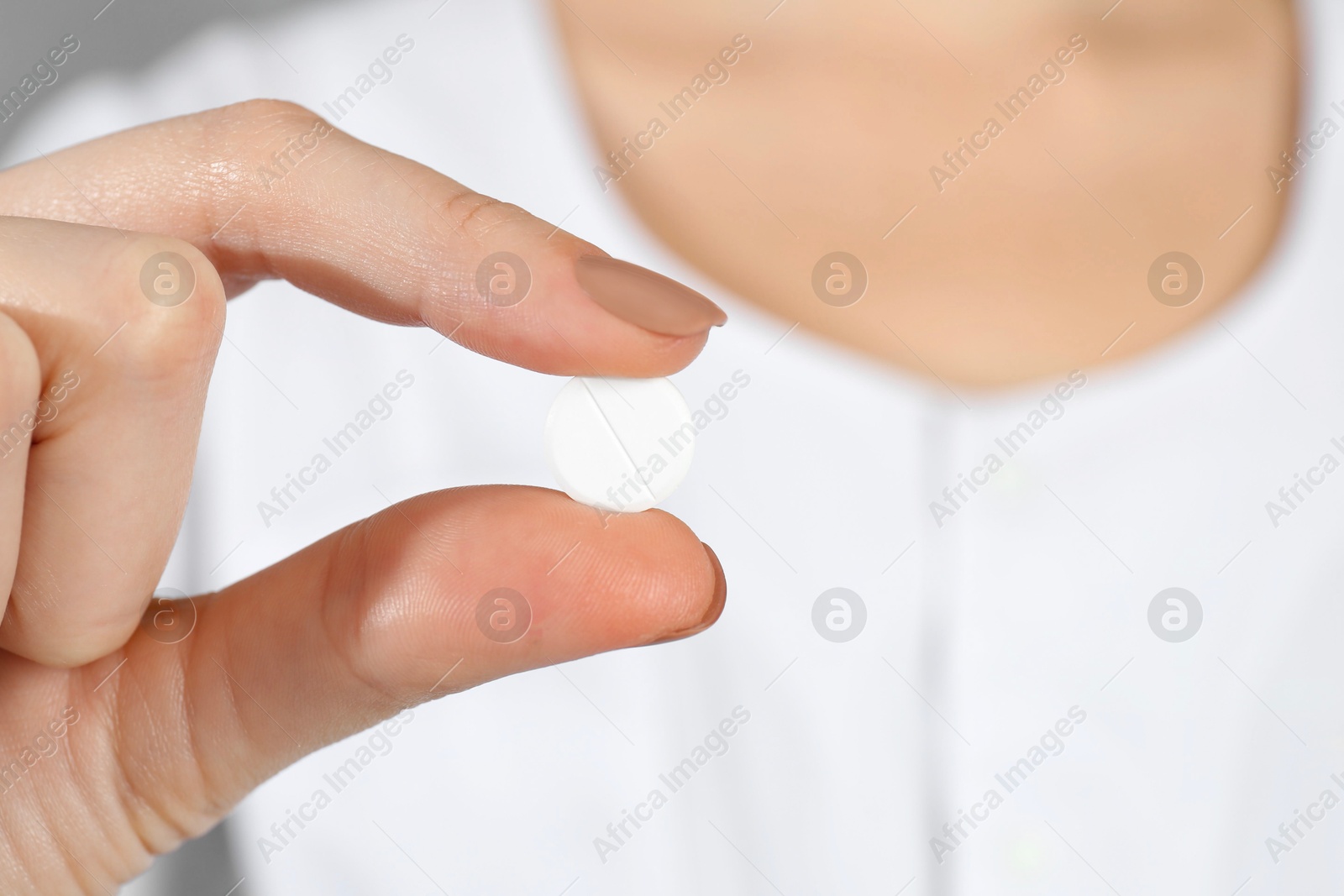 Photo of Woman holding antibiotic pill, closeup. Selective focus