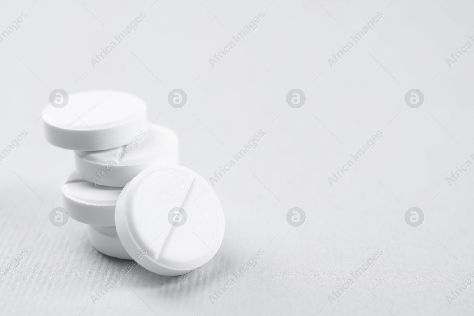 Photo of Antibiotic pills on grey background, closeup. Space for text