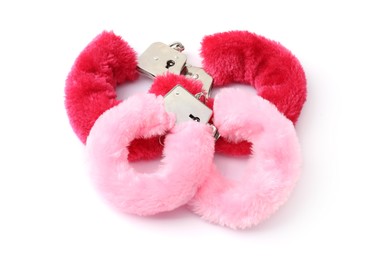 Photo of Pink fluffy handcuffs isolated on white. Sex toy