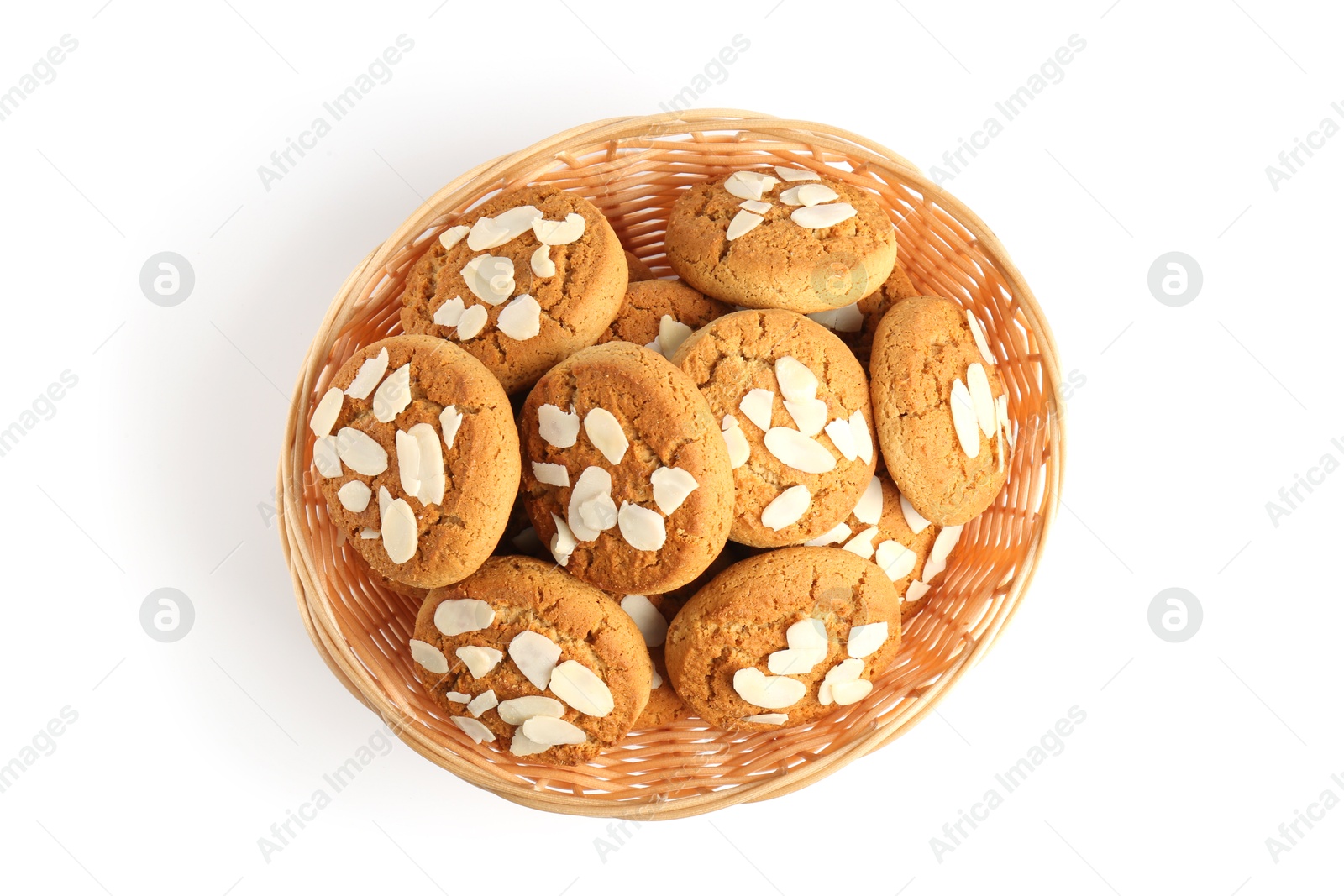 Photo of Tasty cookies with almond flakes in wicker basket isolated on white, top view