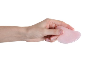 Woman holding gua sha tool on white background, closeup