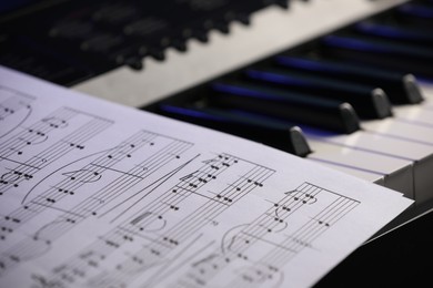 Photo of Sheet with musical notes on piano, closeup