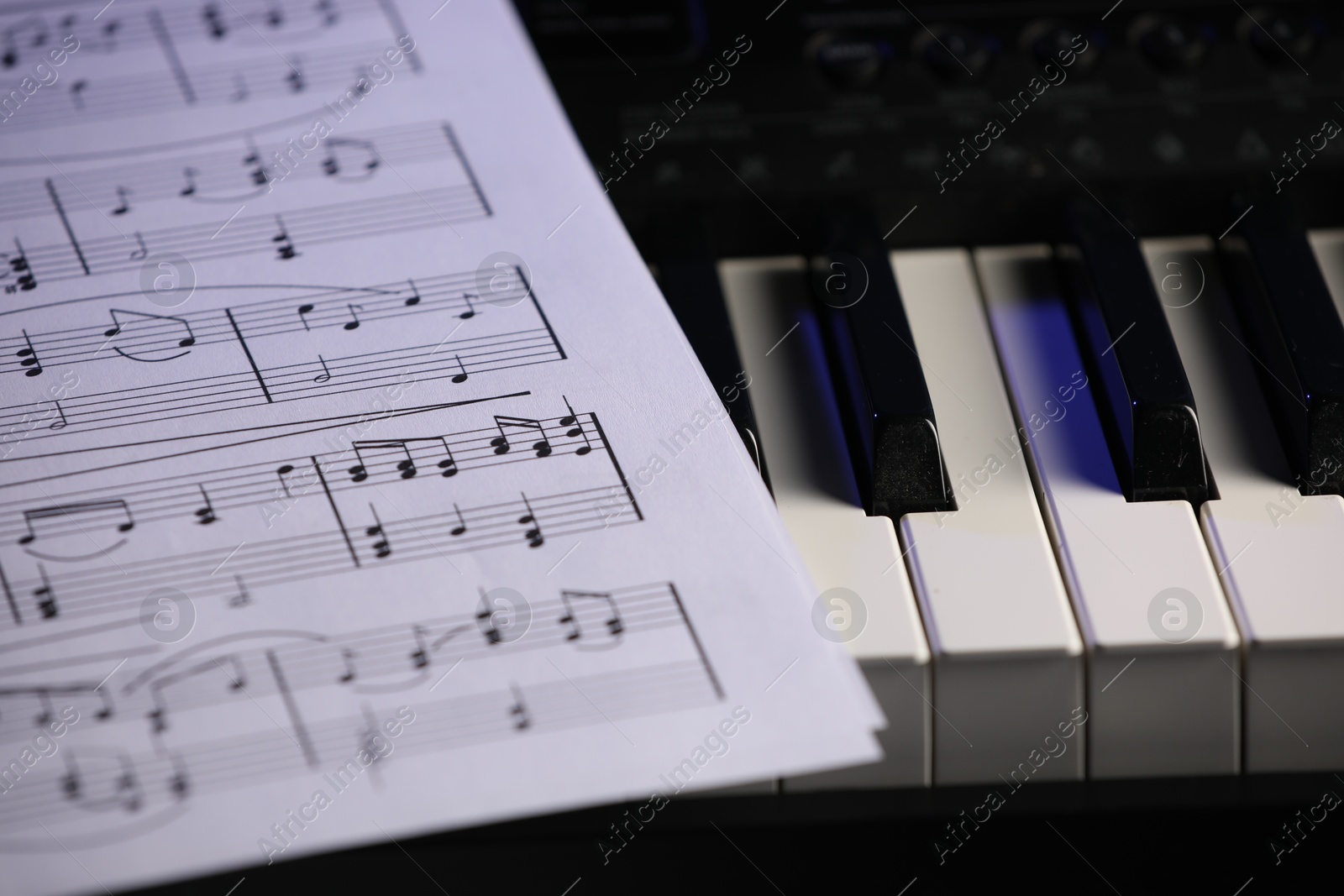 Photo of Sheet with musical notes on piano, closeup