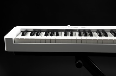 Photo of Synthesizer on black background, closeup. Electronic musical instrument