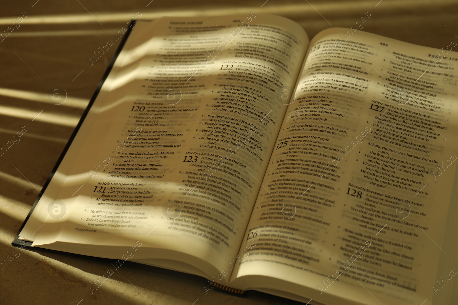 Photo of Open Holy Bible in English language on table