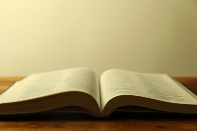 Open Holy Bible in English language on wooden table, closeup