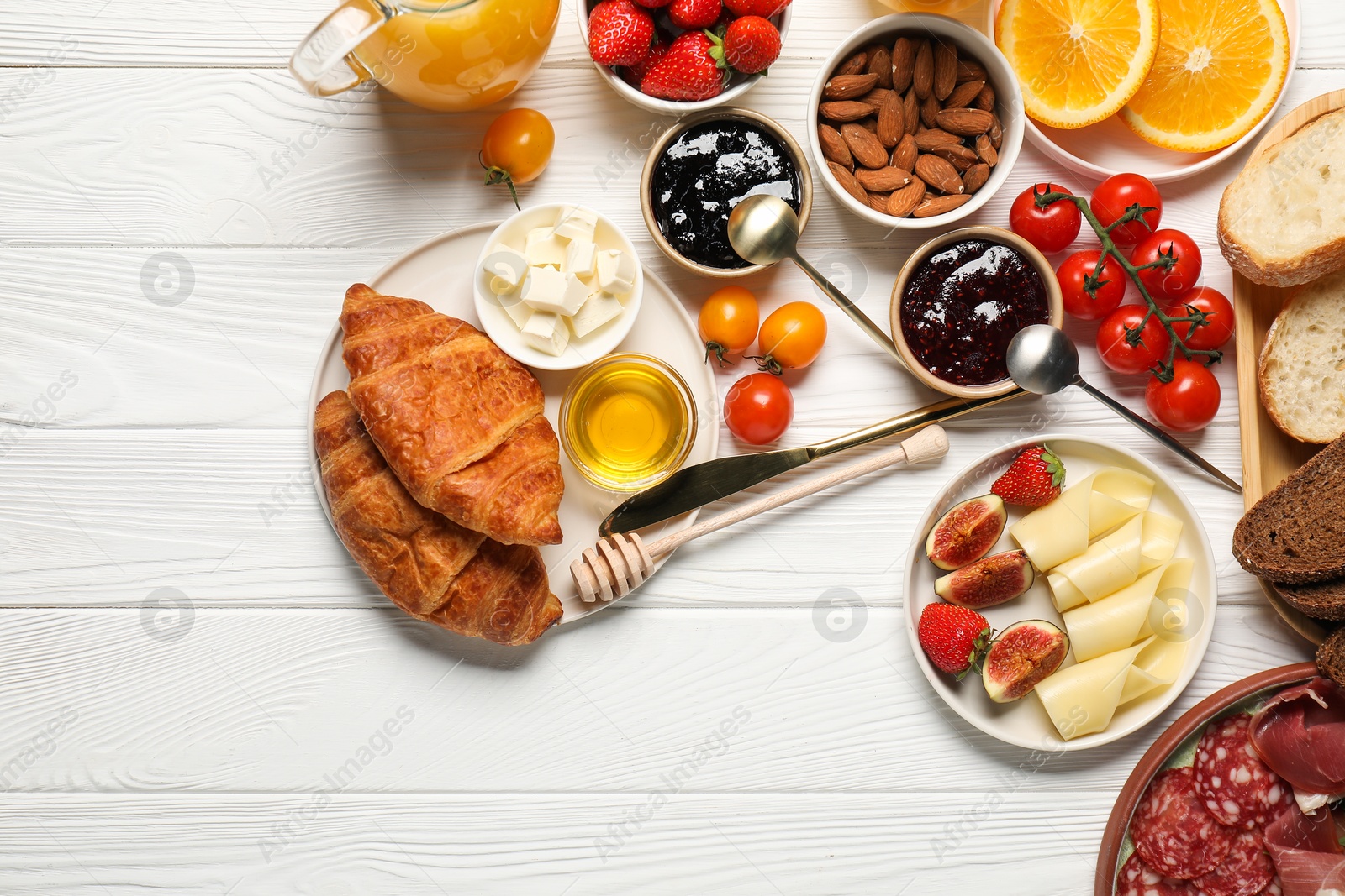 Photo of Different tasty food served for brunch on white wooden table, flat lay