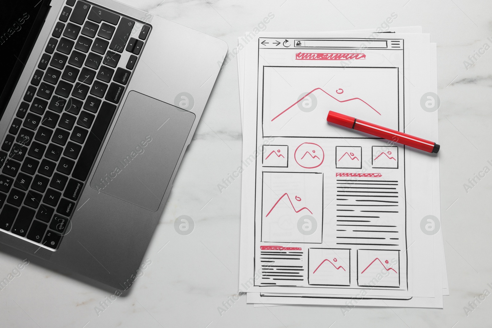 Photo of Developing UI design. Sketches of website wireframes, laptop and felt pen on white marble table, top view