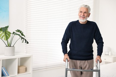 Photo of Senior man with walking frame in hospital ward. Space for text