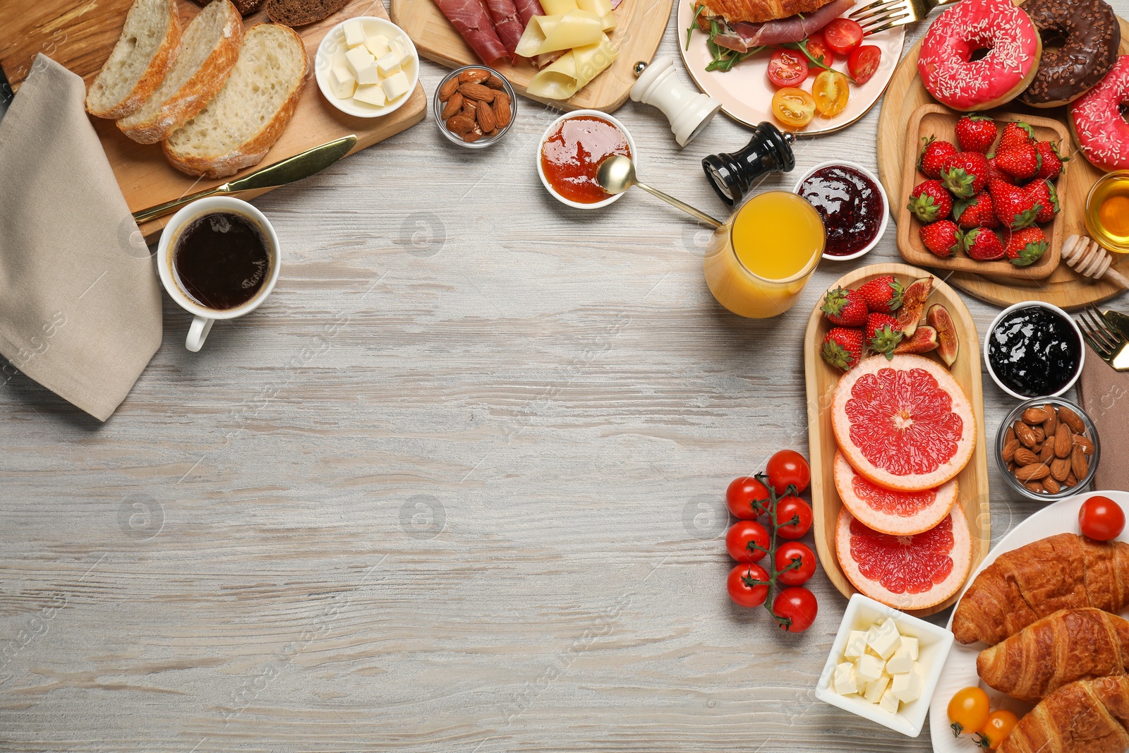 Photo of Different tasty food served for brunch on wooden table, flat lay. Space for text