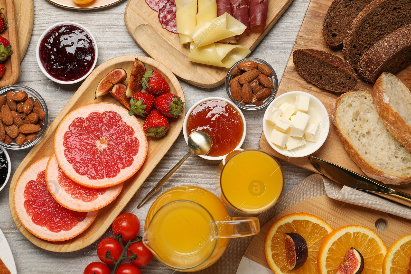 Photo of Different tasty food served for brunch on wooden table, flat lay