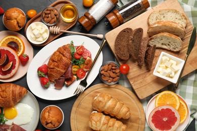 Photo of Different tasty food served for brunch on grey textured table, flat lay