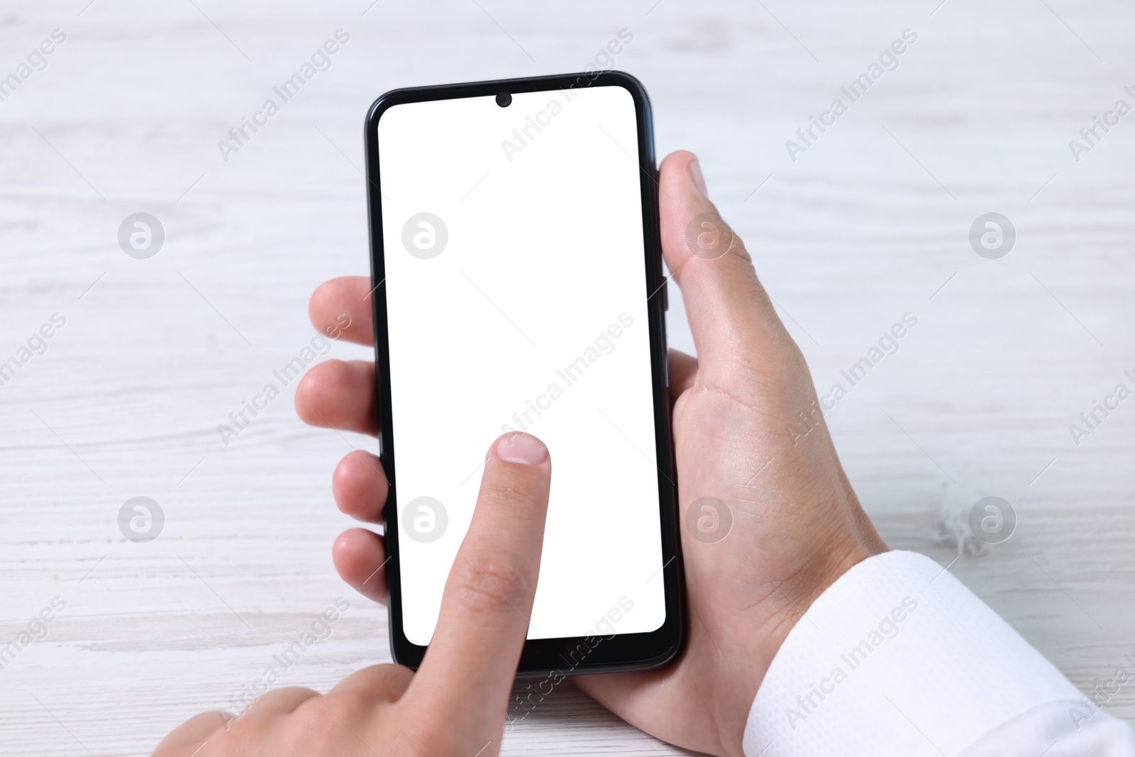 Photo of Man unlocking smartphone with fingerprint scanner at light wooden table, closeup