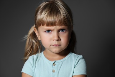 Photo of Orphanage concept. Sad little girl on grey background